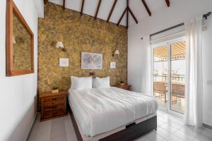 a bedroom with a large bed and a balcony at Benny Fañabé - 2 Bed and Loft Apartment, AC, Pool & Parking in Adeje