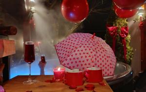 a red and white polka dot umbrella sitting on a table at Agroturystyka u Lusi in Rytel +145 photos