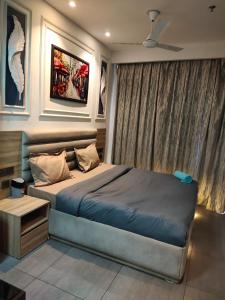 a bedroom with a large bed in a room at Landin2home studios in New Delhi
