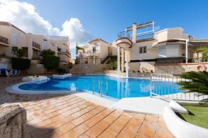 a swimming pool in front of a building at Benny Fañabé - 2 Bed and Loft Apartment, AC, Pool & Parking in Adeje