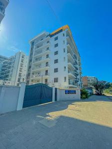 a large apartment building with a fence in front of it at Aqua Epic Residence in Mombasa