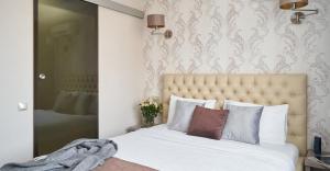a bedroom with a large bed with white sheets and pillows at Готель Дружба in Kyiv