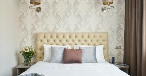 a bedroom with a large bed with a large headboard at Готель Дружба in Kyiv