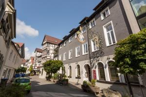 a street with buildings and a car parked on the street at Bischoffs Hotel in Bad Urach