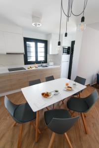 a white table and chairs in a kitchen at Los Cardones Boutique Village in Playa de las Americas