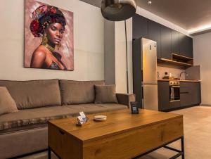 a living room with a couch and a table at Siel simple elegance Volos in Volos