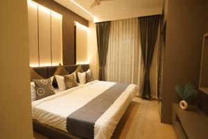 a bedroom with a large bed in a room at The Grand Sarayu in Mysore