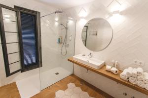 a white bathroom with a sink and a shower at Los Cardones Boutique Village in Playa de las Americas