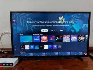 a flat screen tv sitting on top of a wooden table at Savan Villa Hotel in Savannakhet