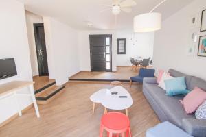 a living room with a couch and a table at Los Cardones Boutique Village in Playa de las Americas