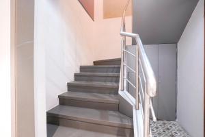 a staircase in a house with a metal railing at FabHotel Suruchi Homes in Vasai