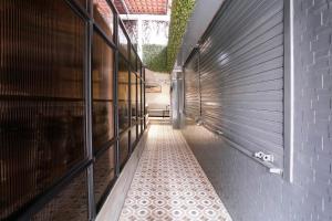 a hallway with a tile floor in a building at FabHotel Suruchi Homes in Vasai +45 photos