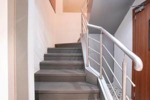a staircase in a house with grey stairs at FabHotel Suruchi Homes in Vasai