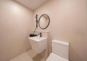 a bathroom with a toilet and a mirror on the wall at No 25 Iksan Station Branch in Iksan