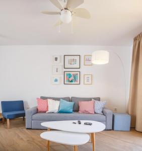 a living room with a couch and a table at Los Cardones Boutique Village in Playa de las Americas