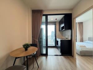 a room with a table and a bed and a kitchen at NUE District Rama 9 Condo in Bangkok +54 photos