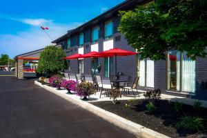a group of chairs and umbrellas outside of a building at Comfort Inn Belleville in Belleville