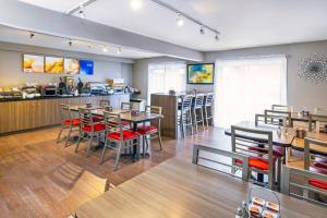 a restaurant with tables and chairs and a counter at Comfort Inn Belleville in Belleville