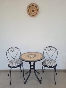 two chairs and a table with a table and a table and chairs at Guest House Harmony in Veliko Tŭrnovo