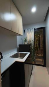 a small kitchen with a sink and a window at Hillside - Seashore Naiyang Beach in Phuket +3 photos