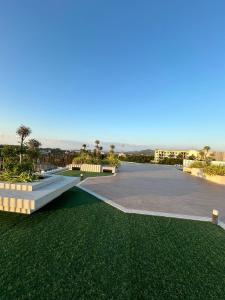 a walkway with green grass next to a parking lot at Hillside - Seashore Naiyang Beach in Phuket
