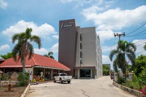 a white truck parked in front of a building at Lima Hotel in Phra Nakhon Si Ayutthaya