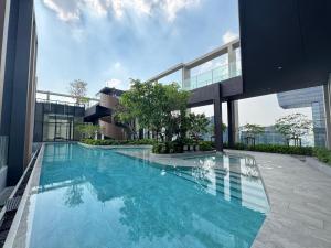 a large swimming pool on the side of a building at NUE District Rama 9 Condo in Bangkok