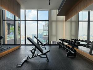 a gym with rows of chairs and large windows at NUE District Rama 9 Condo in Bangkok