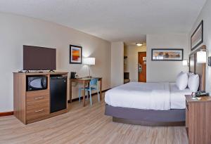a hotel room with a bed and a flat screen tv at Quality Inn Milan-Sandusky in Milan +78 photos