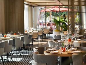a dining room with tables and chairs with wine glasses at Banyan Tree Dubai at Bluewaters in Dubai