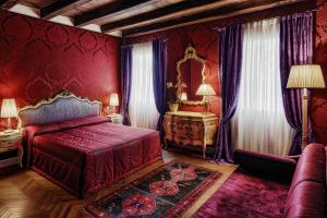 a red bedroom with a bed and a mirror at B&B Bloom Settimo Cielo in Venice