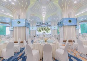 a banquet hall with white tables and chairs and a chandelier at Won Majestic Hotel Cambodia in Sihanoukville +85 photos
