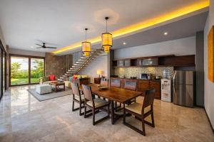 a kitchen and dining room with a table and chairs at Seminyak Icon - by Karaniya Experience - CHSE certified in Seminyak