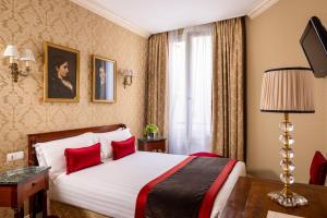 a hotel room with a bed with red pillows at Hotel De Seine in Paris +88 photos