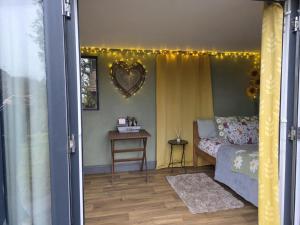 a bedroom with a bed and a table with a mirror at Ty Grug Retreat in Little Newcastle
