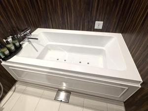 a white bath tub in a bathroom with wooden walls at Carnet (Adult Only) in Amagasaki +28 photos
