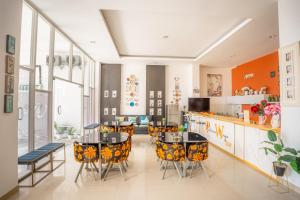 a dining room with a table and chairs at Hotel Pratisarawirya by The Loka in Surabaya +77 photos