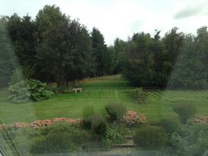 a view of a garden from a window at Country B&B Horsens in Horsens