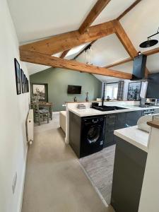 a kitchen with a washing machine in the middle at Red Rose Cottage in Cockermouth