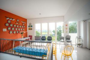 a dining room with a table and chairs at Hotel Pratisarawirya by The Loka in Surabaya
