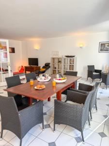 a dining room with a wooden table and chairs at L'Escale St Nicolas in Hennebont