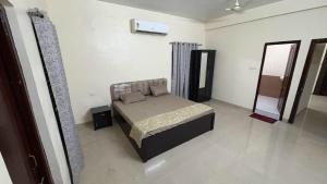 a bedroom with a bed and a mirror at Elite Villa Raipur - Luxury Homestay in Raipur