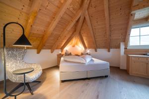 a bedroom with a bed and a table and a chair at Panorama Hotel Himmelreich in Kastelbell-Tschars +104 photos