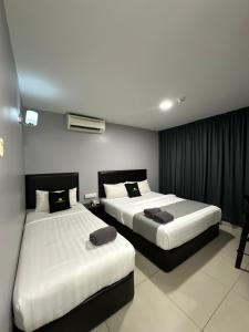 a hotel room with two beds in a room at Royale City Hotel - 10 min from KLIA KLIA 2 Airport in Sepang