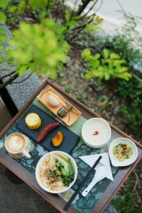 a tray of food on a table with food on it at Seven Letters Preface Hotel Xijiang Qianhu Miao Village in Xijiang