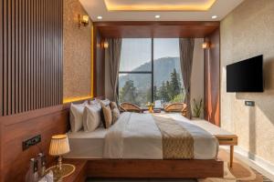 a bedroom with a large bed with a large window at Perfectstayz Luxe kapilaz - Jacuzzi rooms in Bhowāli