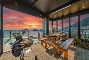 a dining room with a table and a view of the ocean at Yeosu View21 Pension in Yeosu