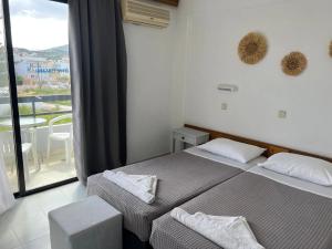 a bedroom with two beds and a balcony at Smart Accomodation Rhodes by GHH in Rhodes Town +28 photos