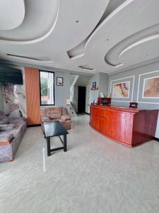 a living room with a desk and a couch at Mbogo Safari Hotel in Karatu