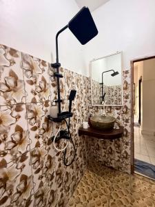 a bathroom with a flower patterned wall at Solara Gili Air in Gili Islands +2 photos